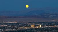 Vollmond über Las Vegas, im Hintergrund Wüste und Berge. Keine Fotomontage oder dergleichen.